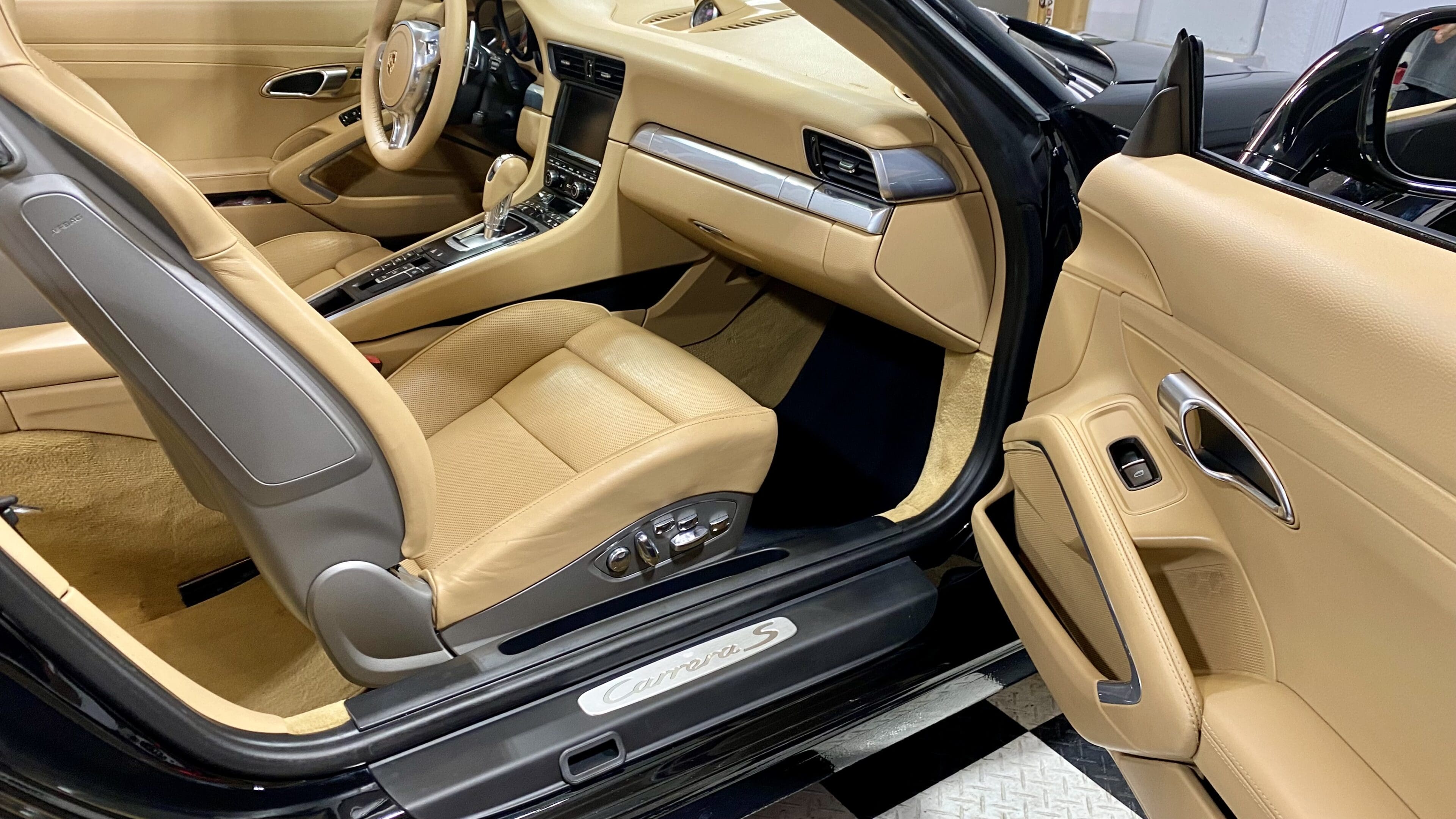 A car with tan leather seats and black trim.