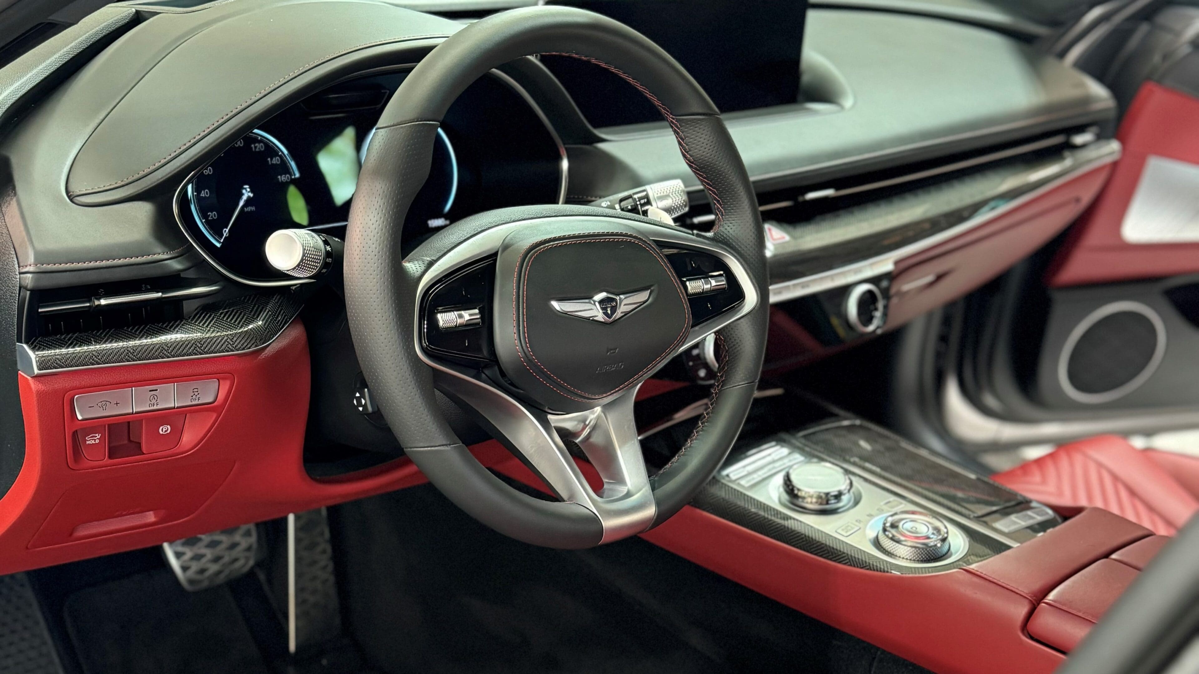 A close up of the steering wheel and dashboard in a car